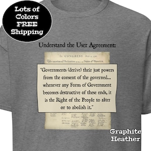 May include: Graphite heather t-shirt with the text "Understand the User Agreement" and a quote from the Declaration of Independence. The shirt also has a circular graphic that says "Lots of Colors FREE Shipping".