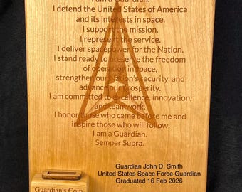 May include: A wooden plaque with the text "GUARDIAN IDEAL" and a poem about being a Guardian. Includes a small wooden coin holder with a coin that reads "Guardian's Coin". The plaque also lists a name, title, and graduation date.