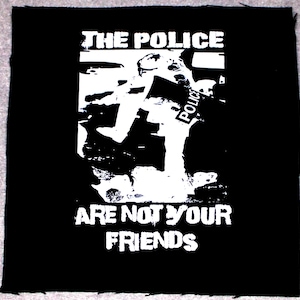 May include: Black and white patch with the text "The Police Are Not Your Friends" and a graphic of a police officer running.