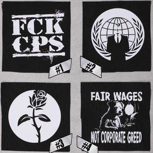 May include: Four black and white iron-on patches. The first patch says "FCK CPS". The second patch has a white circle with a globe and laurel wreath around it. The third patch has a white circle with a rose. The fourth patch says "FAIR WAGES NOT CORPORATE GREED".