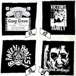 May include: Four black and white patches with band logos. The top left patch features a green and white logo for "Gang Green" with the text "King of Bands" and "World's Loudest Drunkest Band". The top right patch features a black and white logo for "Victims Family". The bottom left patch features a black and white logo for "Broken Bones". The bottom right patch features a black and white logo for "Negative Approach".