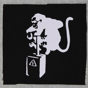 May include: A white silhouette of a monkey sitting on a white box with a warning sign. The monkey is holding a stick and has a long tail. The image is on a black background.