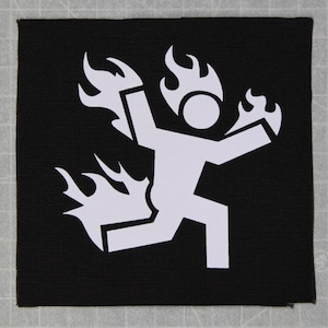 May include: White silhouette of a stick figure running with flames on its head and behind it on a black background.