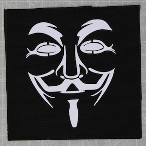 May include: A white outline of the Anonymous mask on a black background. The mask features a stylized face with a wide smile and a prominent nose.