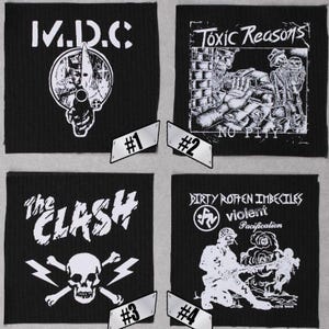 May include: Four black and white patches with band logos. The patches are numbered 1 through 4. Patch 1 features the logo for the band "M.D.C.". Patch 2 features the logo for the band "Toxic Reasons" with the text "No Pity". Patch 3 features the logo for the band "The Clash" with a skull and crossbones. Patch 4 features the logo for the band "Dirty Rotten Imbeciles" with the text "Violent Pacification".