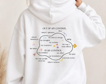 May include: A white hooded sweatshirt featuring a graphic on the back with the text OUT OF MY CONTROL and IN MY CONTROL. The design includes a central organic shape containing phrases like my thoughts, my actions, and my mindset, surrounded by small colorful icons like stars, flowers, and cherries.