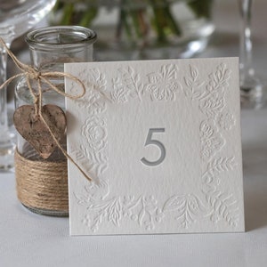 Números de mesa impresos con tipografía Bloom