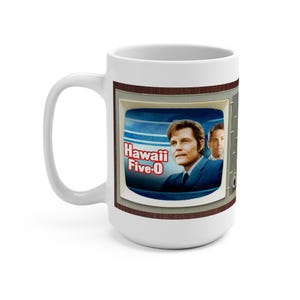 May include: White ceramic mug featuring a retro television screen design with the words "Hawaii Five-0" and images of actors. The mug has a brown border and a white handle.