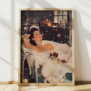 May include: A framed vintage-style print depicts a woman relaxing in a bubble-filled bathtub with a small dog. The woman, with dark hair and red lipstick, is smiling. The print has a warm, inviting color palette and a retro aesthetic.
