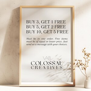 May include: A framed sign with a white background and black text that reads "BUY 3, GET 1 FREE, BUY 5, GET 2 FREE, BUY 10, GET 5 FREE". Below the text is a smaller font that reads "Must be in one order. Free items must be of equal or lower price. Just send us a message with your choices." The bottom of the sign has the text "VAB COLOSSAL CREATIVES".
