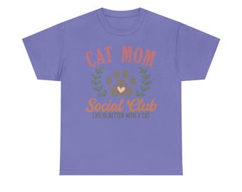 May include: Purple short-sleeved t-shirt with the text "Cat Mom Social Club" and the words "Life is better with a cat" in a smaller font.