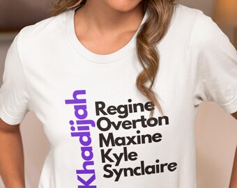 May include: White t-shirt with a purple vertical design that reads "Khadijah" and a list of names in black text: "Regine, Overton, Maxine, Kyle,  Synclaire"