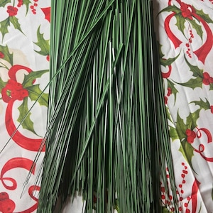 May include: A bunch of green floral wire stems. The wire is thin and flexible, and it is perfect for crafting and floral arrangements.