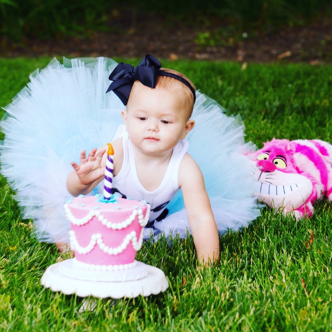 Baby Davina (aka Alice in Wonderland) was serious about her Cake! 🎂 Happy  First Birthday to this sweet girl! I had so much fun putting this -  Natalie Buck Photography - Connecticut