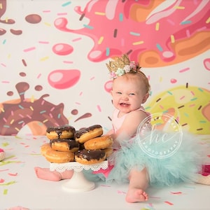 1 handmade Donut Grow Up birthday tutu on stretch elastic, 1 Donut Grow Up themed bodysuit, 1 single hair bow or flower on a stretch elastic headband.