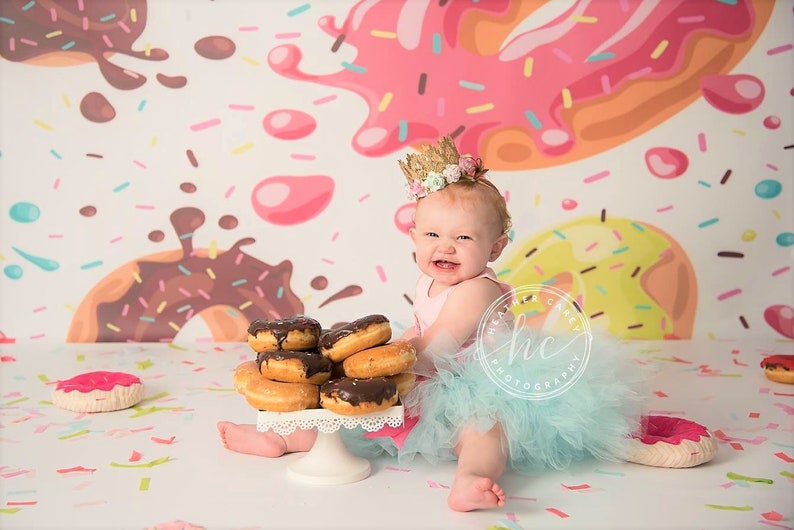 1 handmade Donut Grow Up birthday tutu on stretch elastic, 1 Donut Grow Up themed bodysuit, 1 single hair bow or flower on a stretch elastic headband.