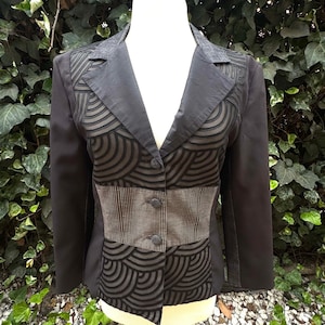 May include: A set of three ceramic mugs with a speckled, matte finish in cream, light grey, and dark grey. Each mug has a simple, minimalist design, suitable for coffee or tea.