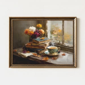 May include: A framed painting of a tranquil autumn scene. A stack of old books with blue covers sits near a window, with a cup of tea on a saucer. Colourful flowers and fallen leaves add warmth to the composition.
