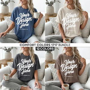 May include: A collection of four t-shirts in different colors: navy blue, beige, charcoal gray, and brown. Each shirt has the text "Your Design Here" in a white script font. The image also includes the text "COMFORT COLORS 1717 BUNDLE" and "12 COLORS".