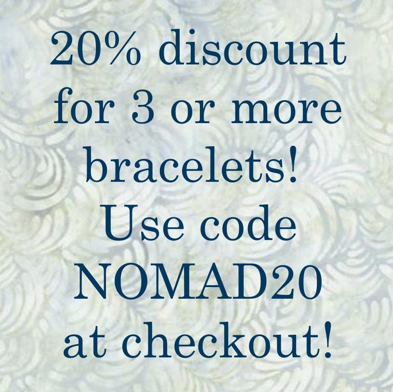 May include: A dark blue text on a light background states: "20% discount for 3 or more bracelets! Use code NOMAD20 at checkout!" The background features a swirling, patterned design in shades of white and light blue.