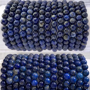 May include: Two stacks of round, dark blue beads with color and pattern variations. The beads are arranged in rows, and the image includes the text "Color and pattern variation in beads."