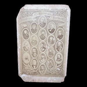 May include: Antique sepia-toned photograph featuring portraits of men in oval frames. The image is labeled "Congress Berlin 1878" with the word "Friedens" above. The photograph has a distressed, aged appearance.