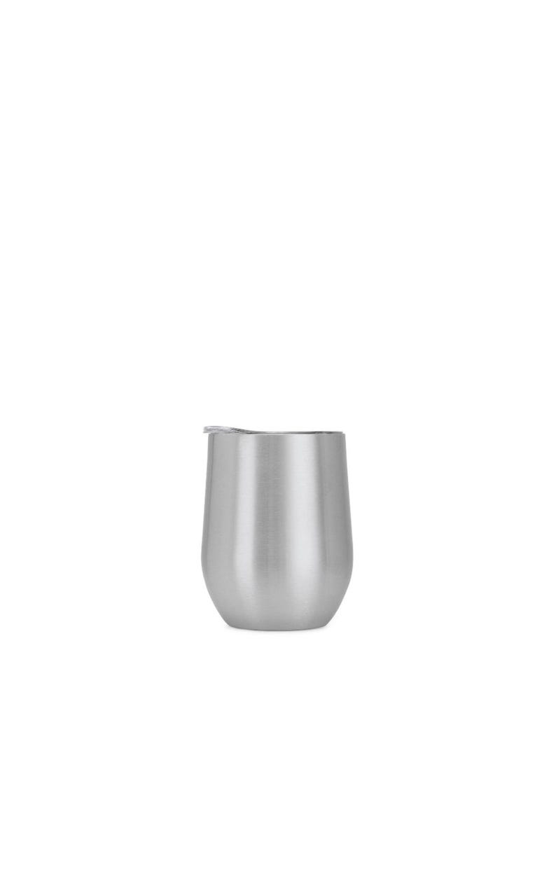 May include: A stainless steel stemless wine tumbler with a lid. The tumbler has a rounded base and a straight, slightly tapered body. The lid is a light gray color. The overall design is sleek and modern.