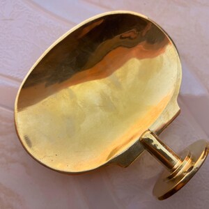 Handcrafted brass soap dish on marble background, wall mounted bathroom accessory.