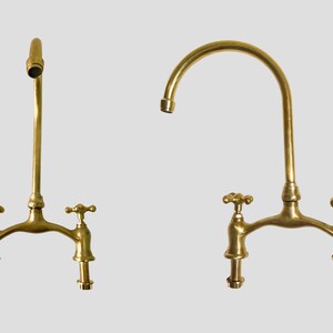 Two angles of handmade unlacquered brass bridge faucet with gooseneck spout.