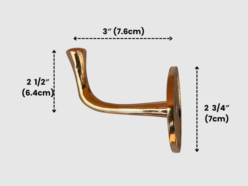 Brass wall hook with measurement overlay.