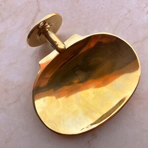 Handcrafted brass soap dish on marble background, wall mounted bathroom accessory.