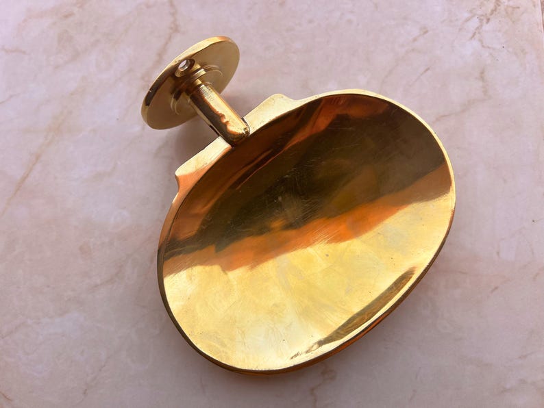 Handcrafted brass soap dish on marble background, wall mounted bathroom accessory.