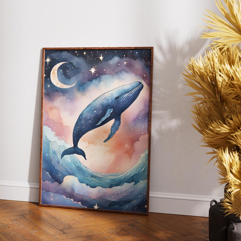 May include: Watercolor art print of a whale soaring through a starry night sky. The artwork features a blue whale, a crescent moon, and a dreamy blend of pink, purple, and blue hues. The print is framed in a wooden frame.