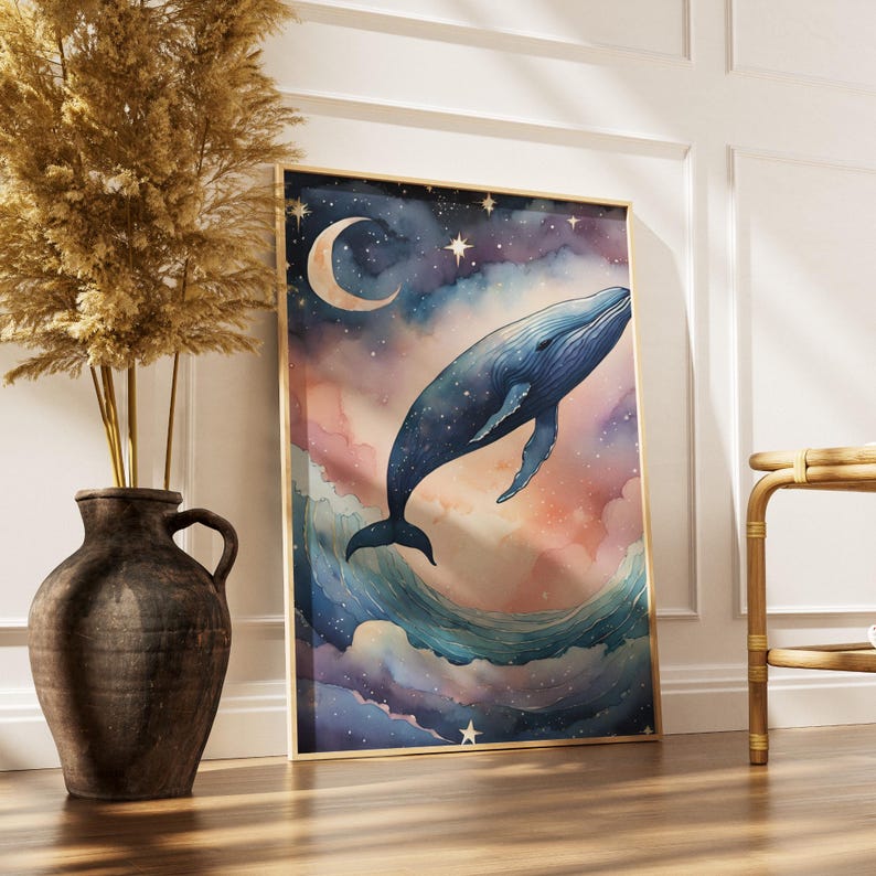 May include: Watercolor art print of a blue whale leaping from ocean waves under a starry night sky with a crescent moon. The artwork has a gold frame and is displayed on a wooden floor.