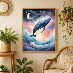 May include: A framed watercolor painting depicts a blue whale leaping from ocean waves into a starry sky with a crescent moon. The artwork features a dreamy color palette of blues, pinks, and purples, creating a whimsical and serene atmosphere. The wooden frame adds a touch of warmth.