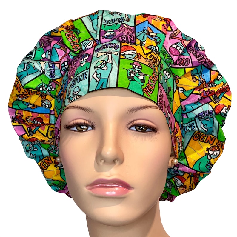 May include: A colorful surgical scrub hat with a comic book style design featuring medical specialties like "Neuro", "Spine", "Ortho", "Uro", and "Plastic".