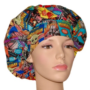 May include: A colorful surgical scrub hat with a Star Wars and Mandalorian comic book print. The hat features characters like Yoda, Grogu, and Boba Fett.