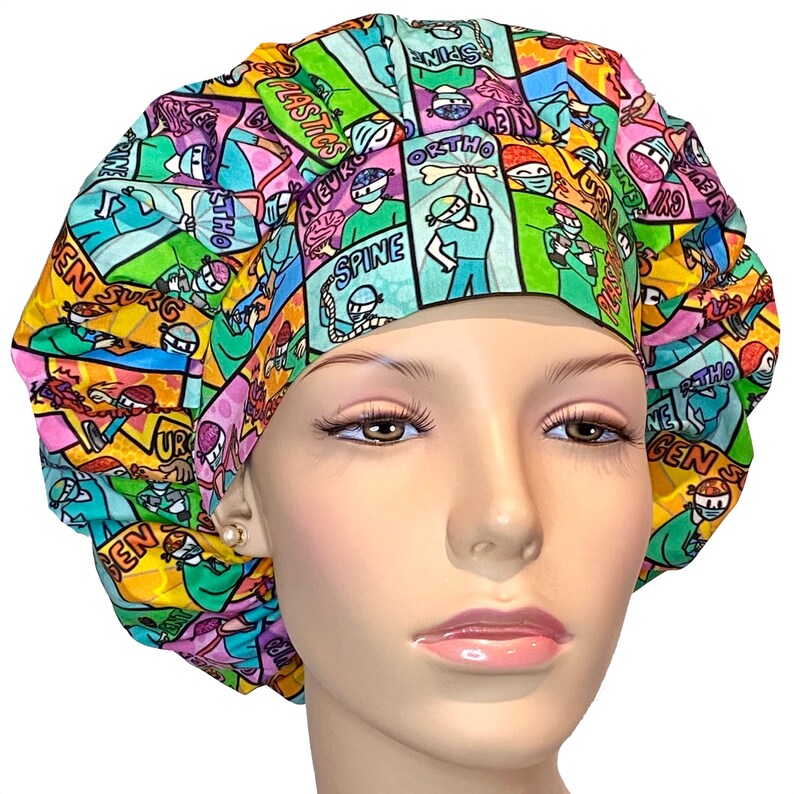 May include: A colorful surgical scrub hat with a comic book style print featuring various medical specialties, including 'Neuro', 'Spine', 'Ortho', 'Plastics', 'Gen Surg', and 'ENT'.