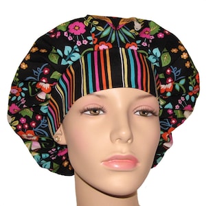 May include: A black scrub hat with a colorful floral print and a black and rainbow striped band. The hat is made of soft, comfortable fabric and is perfect for nurses, doctors, and other healthcare professionals.