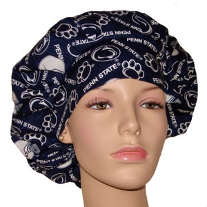 May include: A blue and white patterned surgical scrub hat with the Penn State Nittany Lions logo and paw prints. The hat is made of a soft, comfortable fabric and is perfect for nurses, doctors, and other healthcare professionals.