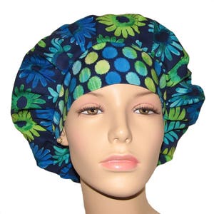 May include: A blue and green patterned surgical scrub cap with a large flower design. The cap is made of a soft, comfortable fabric and is perfect for nurses, doctors, and other healthcare professionals.