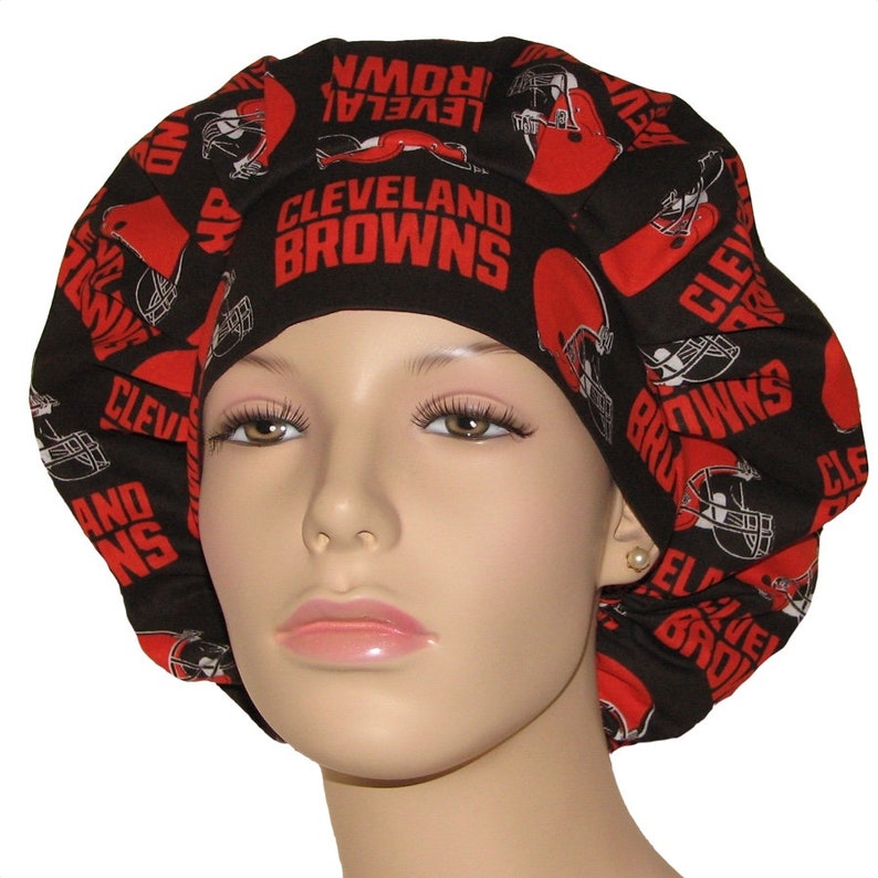 May include: Black and red scrub hat with a repeating pattern of the Cleveland Browns logo and the words "Cleveland Browns".