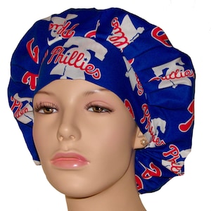 May include: A blue and white Phillies scrub hat. The hat features the Phillies logo and team name in red and white. The hat is made of a soft, comfortable material.