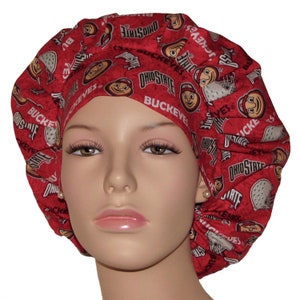 May include: Red and white patterned surgical scrub cap with the Ohio State Buckeyes logo and mascot.