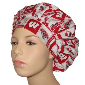 May include: Red and white patterned surgical scrub hat with the University of Wisconsin Badgers logo and the letters "W" and "BADGERS".