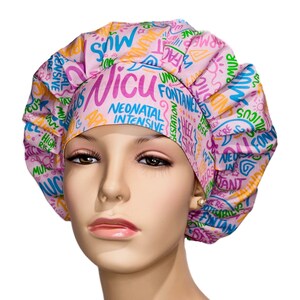 May include: Pink surgical scrub hat with a colorful print of medical terms related to the Neonatal Intensive Care Unit (NICU). The hat has a gathered top and a tie at the back.