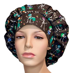May include: A black scrub hat with a colorful print of skeletons dancing and the text "Let's Get Lit" on a black background.