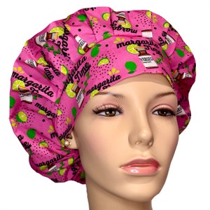 May include: Pink surgical scrub hat with a lime green and black margarita themed print. The print features limes, bottles of tequila, and the text "Margarita Time".