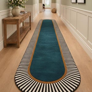 Elegant hallway featuring sage walls, wooden console, floral decor, and a patterned runner rug