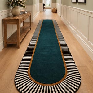 May include: A long, narrow runner rug featuring a solid deep teal centre panel, a thin mustard yellow border, and a wide outer edge decorated with a black and white striped pattern that radiates outwards from the centre in a sunburst design.